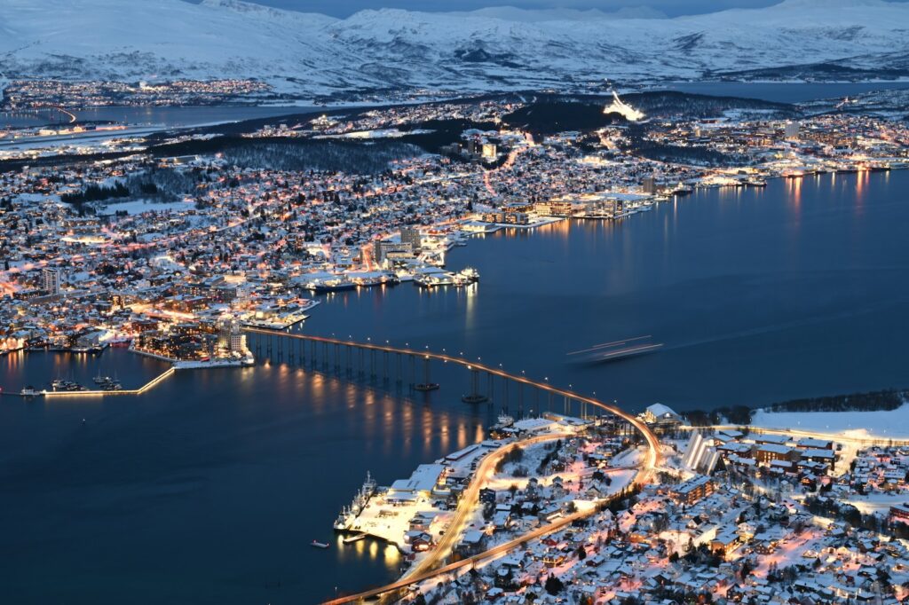 a large body of water surrounded by snow covered mountains